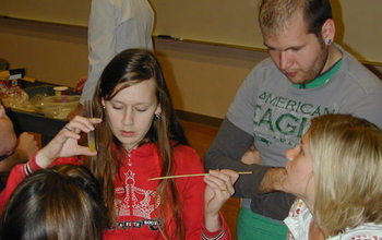 professor with students performing an experiment